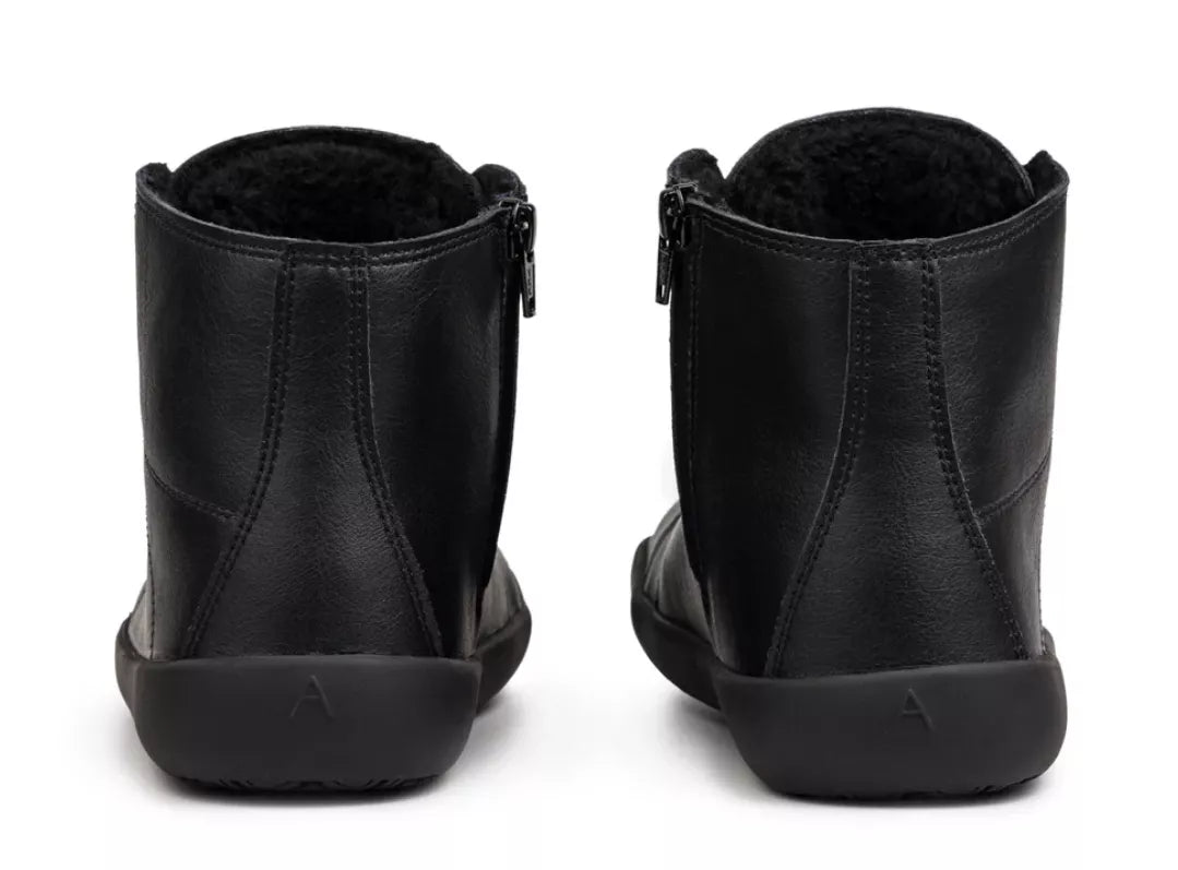 Pair of black barefoot winter boots with ankle height and side zippers, soft lining visible inside.
