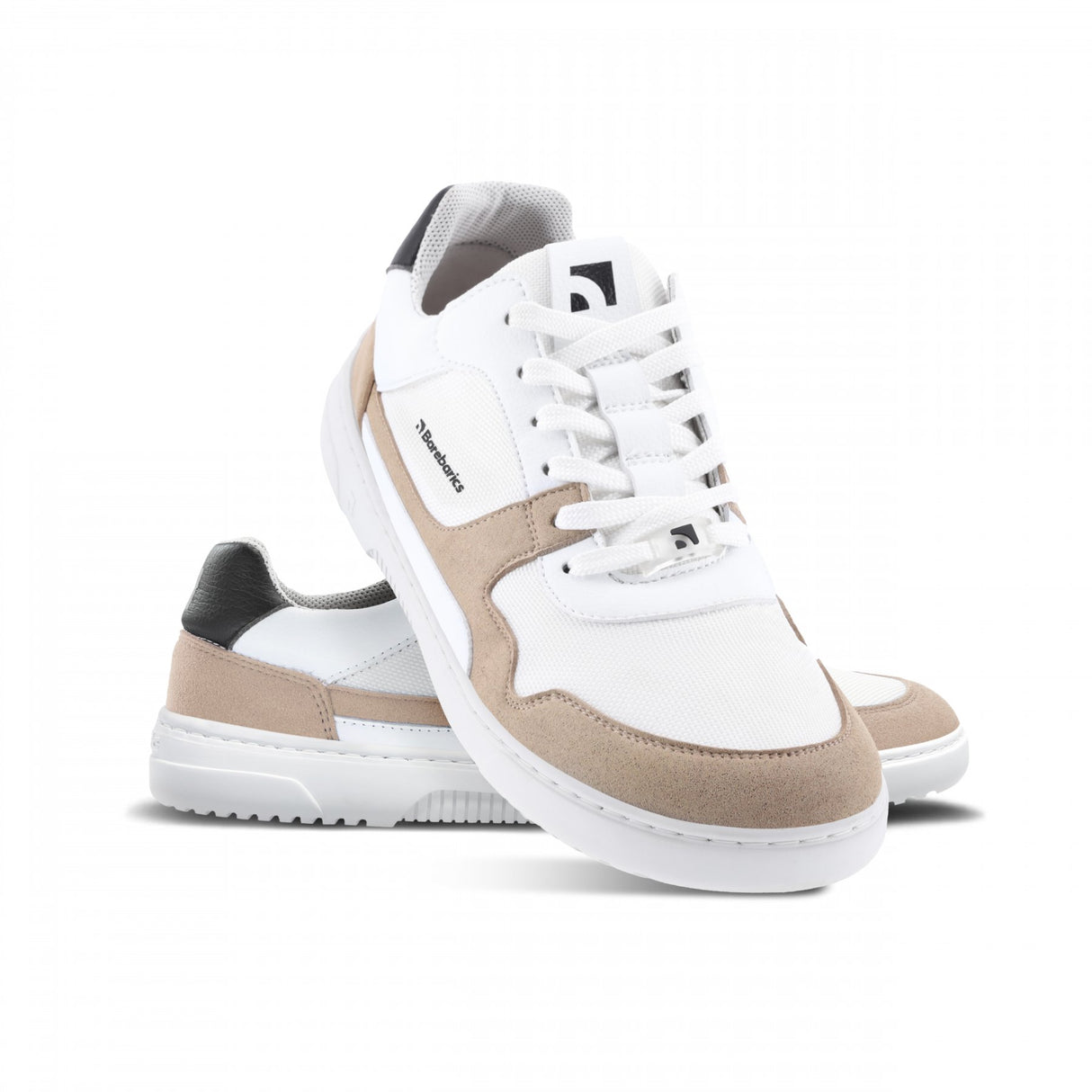 White sneaker with beige suede accents, white laces, and a black heel tab, featuring a minimalist design and a white rubber.
