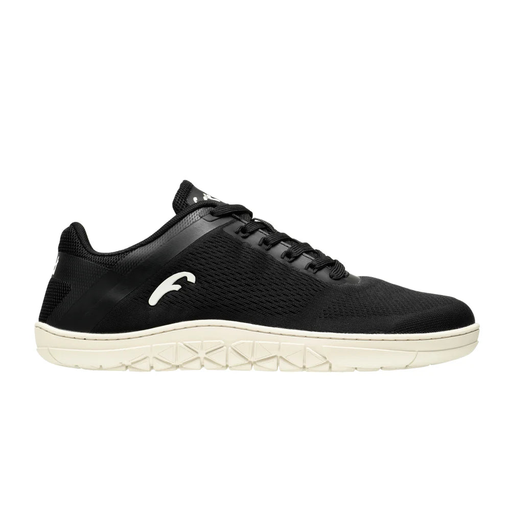 Black low-top sneaker with white textured sole and subtle logo on side.