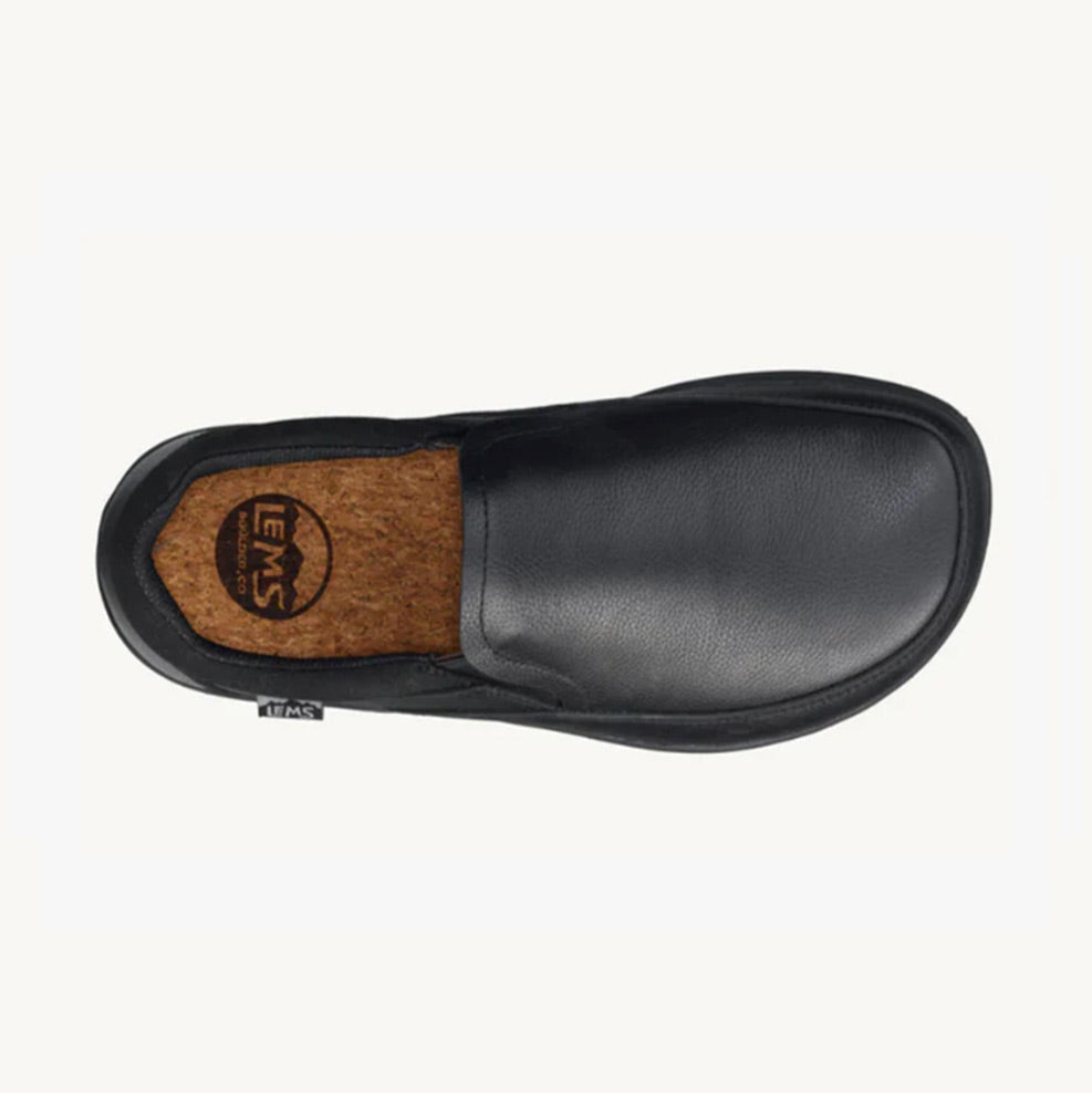 Black slip-on casual shoe with smooth leather upper and cushioned cork insole branded with Lems logo.