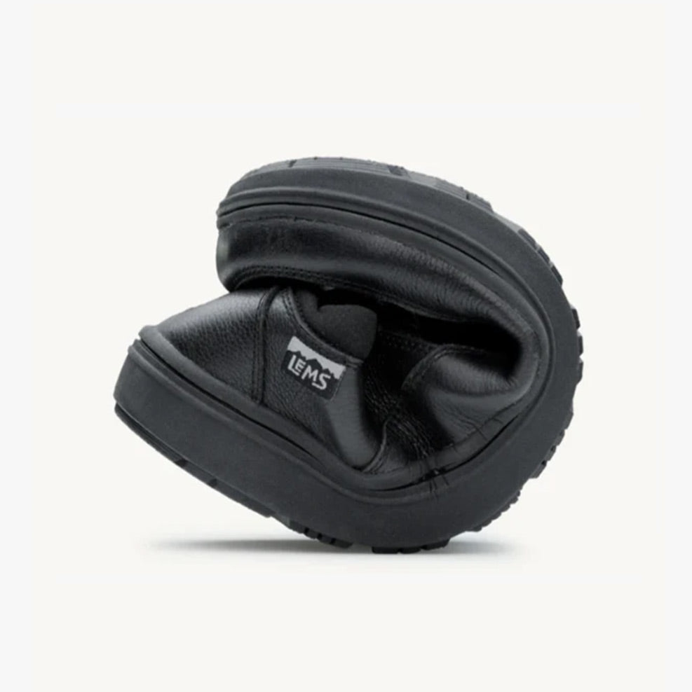 Black Lems Drifter Grip casual shoe folded to show flexibility and soft sole.