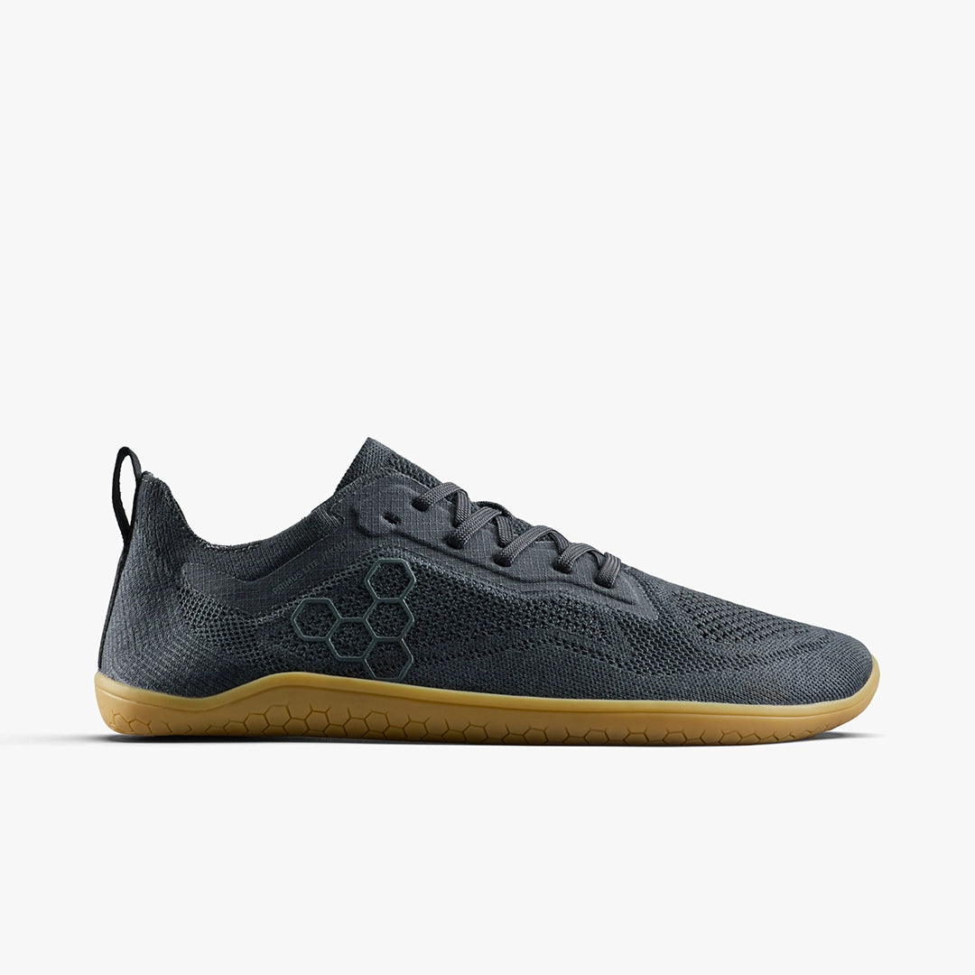 Dark gray athletic shoe with a honeycomb pattern on a white background