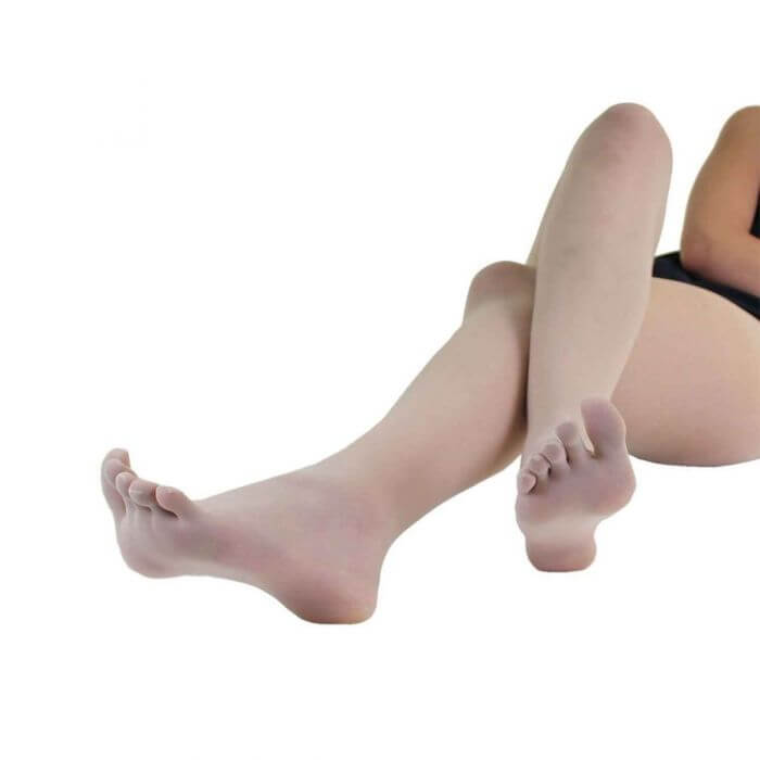 Beige sheer nylon toe tights worn on feet and legs against white background.