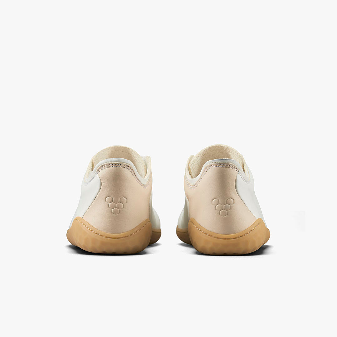 Pair of rose leather Vivobarefoot Geo Court III sneakers with beige accents and gum soles, viewed from the back.