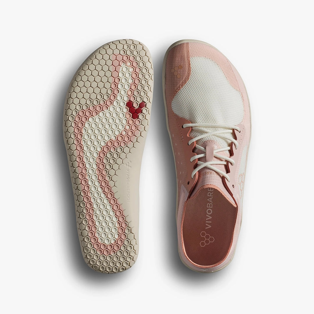 Dusty rose athletic shoe with white toe cap and honeycomb-patterned sole featuring a red Vivobarefoot logo.