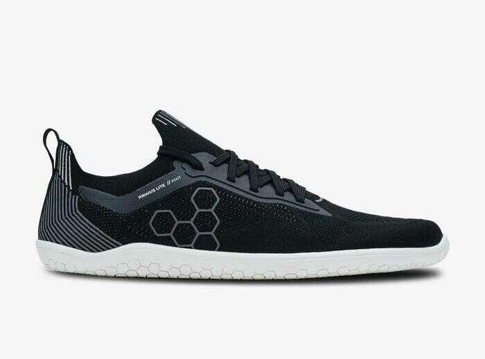 Black knitted low-profile athletic shoe with white sole and hexagonal side pattern.