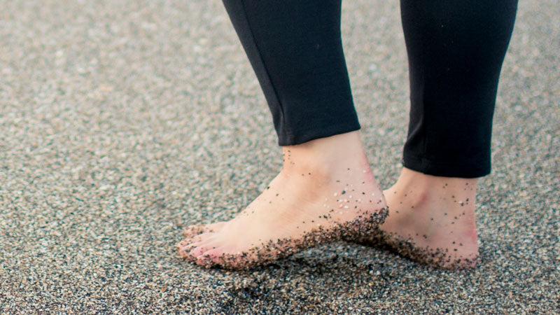 Woman walking on sandy beach