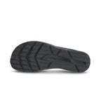 Black athletic shoe outsole with textured, multi-pattern tread designed for traction and durability.