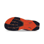 Dark purple and bright orange treaded outsole of athletic shoe with multi-directional grip patterns.