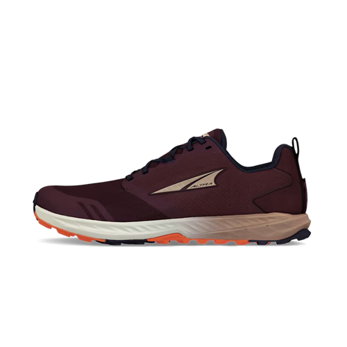 Dark purple women's trail running shoe with beige sole and orange tread, side logo visible.
