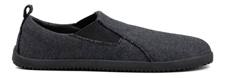 Grey slip-on sneakers with black elastic side panels and textured black soles.