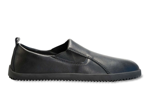 Black vegan leather slip-on sneaker with rounded toe and textured rubber sole.