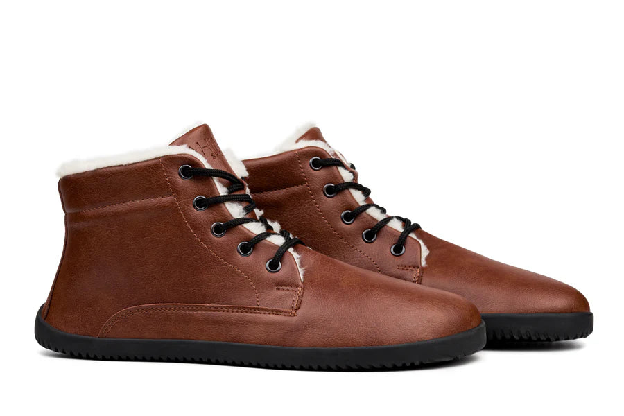 Brown leather ankle boots with black laces and black rubber soles, lined with white fleece.