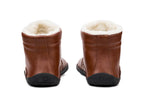 Brown leather ankle boots with plush white fleece lining and black rubber soles, rear view.