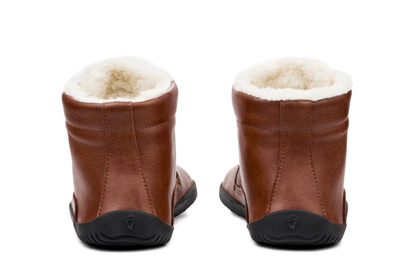 Brown leather ankle boots with plush white fleece lining and black rubber soles, rear view.