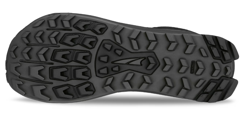 Black rugged trail shoe sole with multidirectional lugs for traction and wide base design.