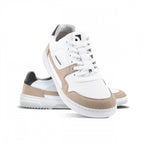 White sneaker with beige suede accents, white laces, and a black heel tab, featuring a minimalist design and a white rubber.