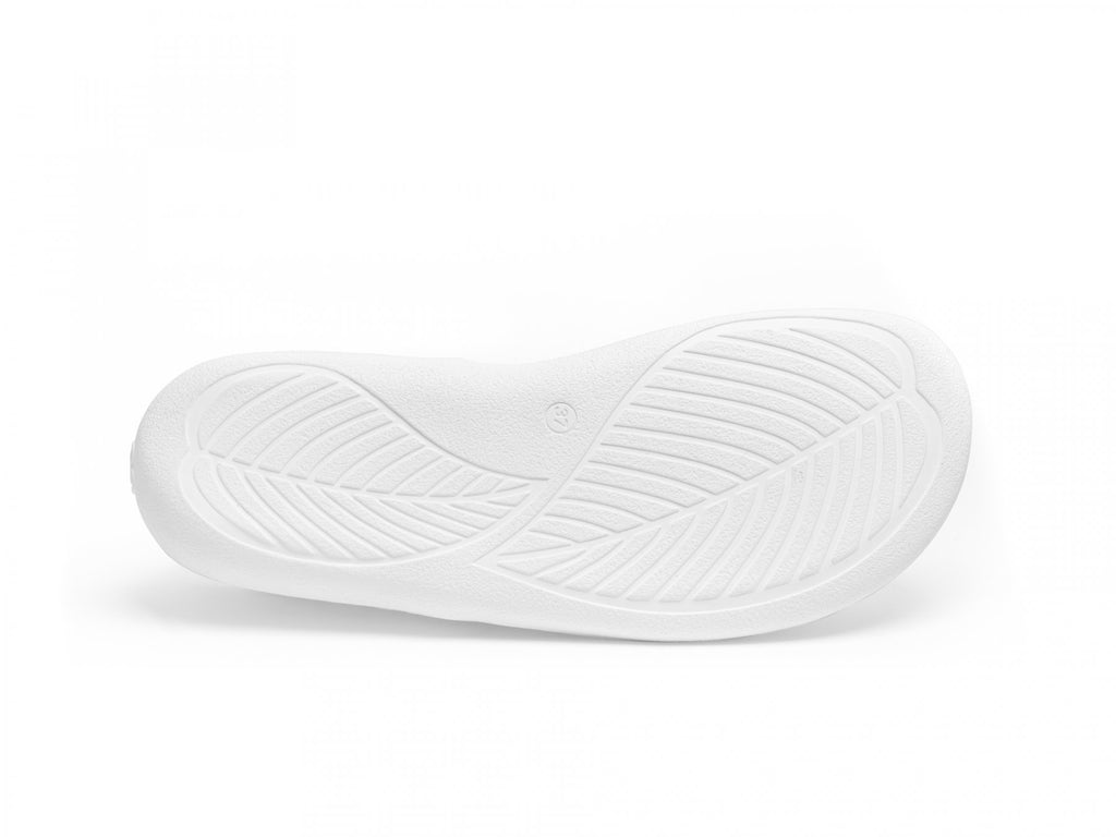 White rubber sole with curved leaf-like textured patterns for grip.