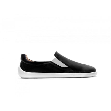 Black slip-on sneaker with smooth upper and white sole, minimalist design.