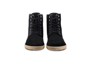Matt black winter boots with lace-up front and light brown rubber soles, front view.
