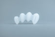 Clear flexible silicone toe spacer with five individual loops for each toe on light gray background.