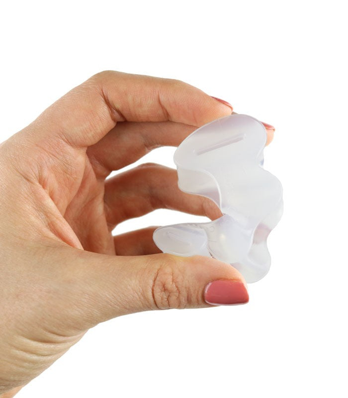 Soft translucent white silicone toe spacer held between thumb and forefinger against white background.