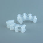 Clear silicone toe spacers with wave-like design, shaped to separate toes comfortably.