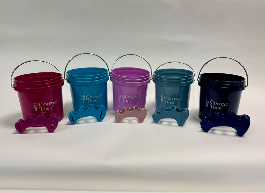 Five small colorful buckets with matching toe separators in aqua, galaxy, mauve, mist, and plum colors, each with a metal.