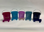 Five small colorful buckets with matching toe separators in aqua, galaxy, mauve, mist, and plum colors, each with a metal.