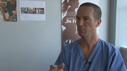 Dr Ray McClanahan In Office Giving Talk on Foot Health