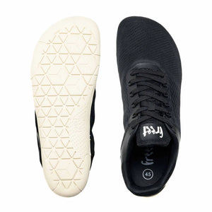 Black minimalist sneaker with breathable mesh upper, white geometric-patterned sole, and lace-up closure.