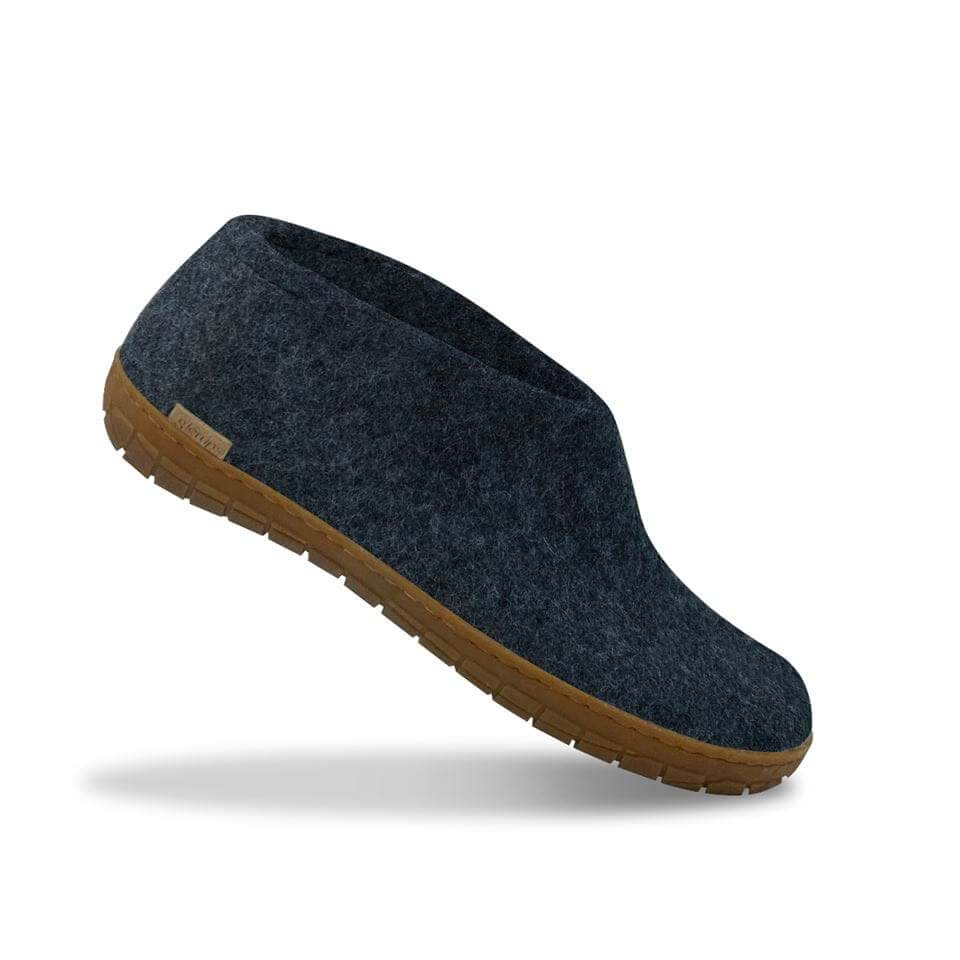 Dark blue felt slip-on shoe with textured honey-colored rubber sole.