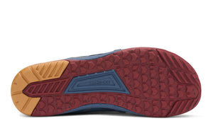 Close-up of a shoe sole with red, blue, and brown colors on a white background