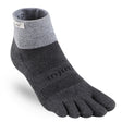 Gray and dark charcoal Injinji five-toe trail sock with cuff label and textured knit pattern.