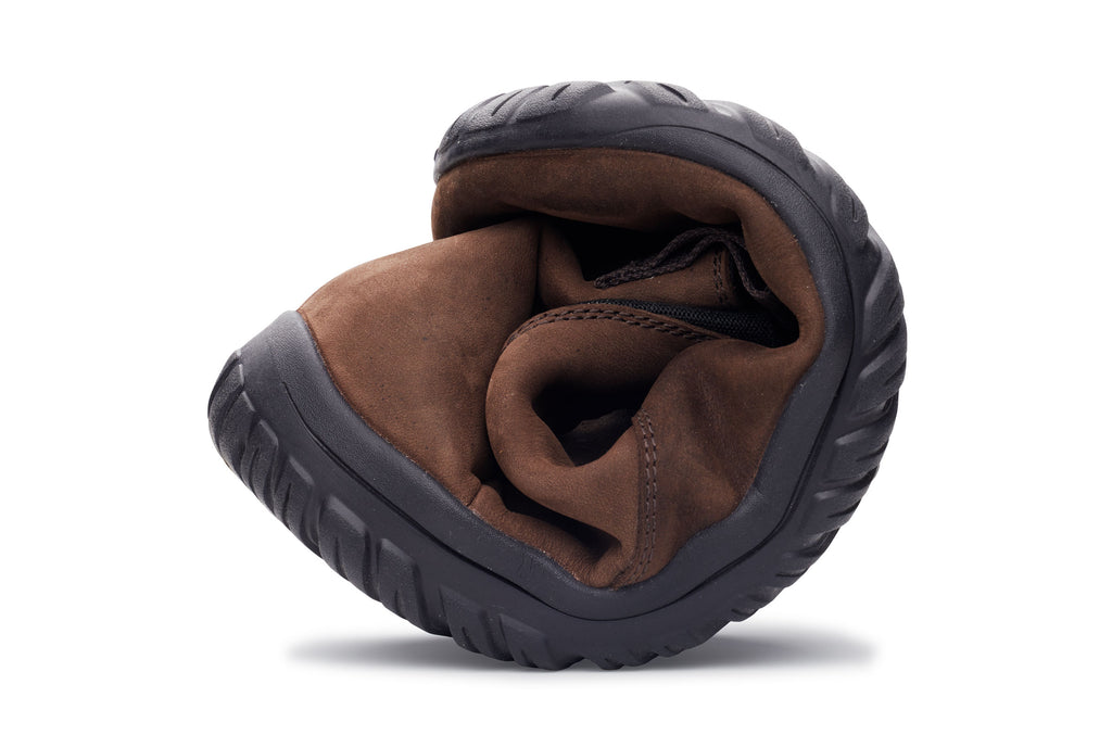 Folded espresso brown waterproof Chelsea boot with black rubber sole and flexible design.