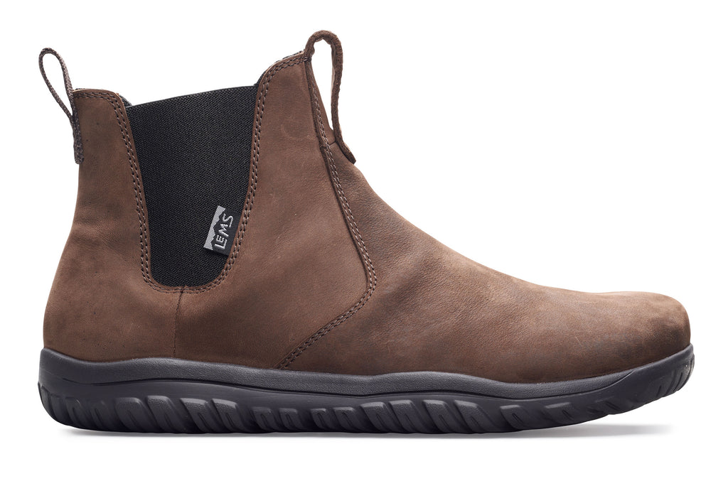 Brown leather Chelsea boot with black elastic side panels and black rubber sole.