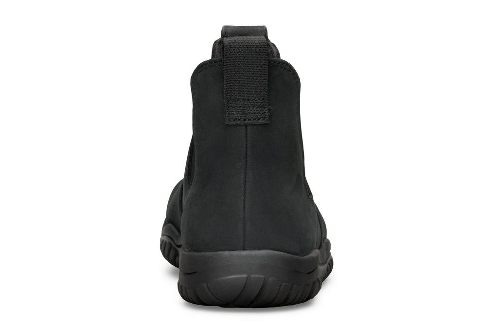 Black waterproof Chelsea boot with smooth matte finish and thick rubber sole, rear pull tab visible.
