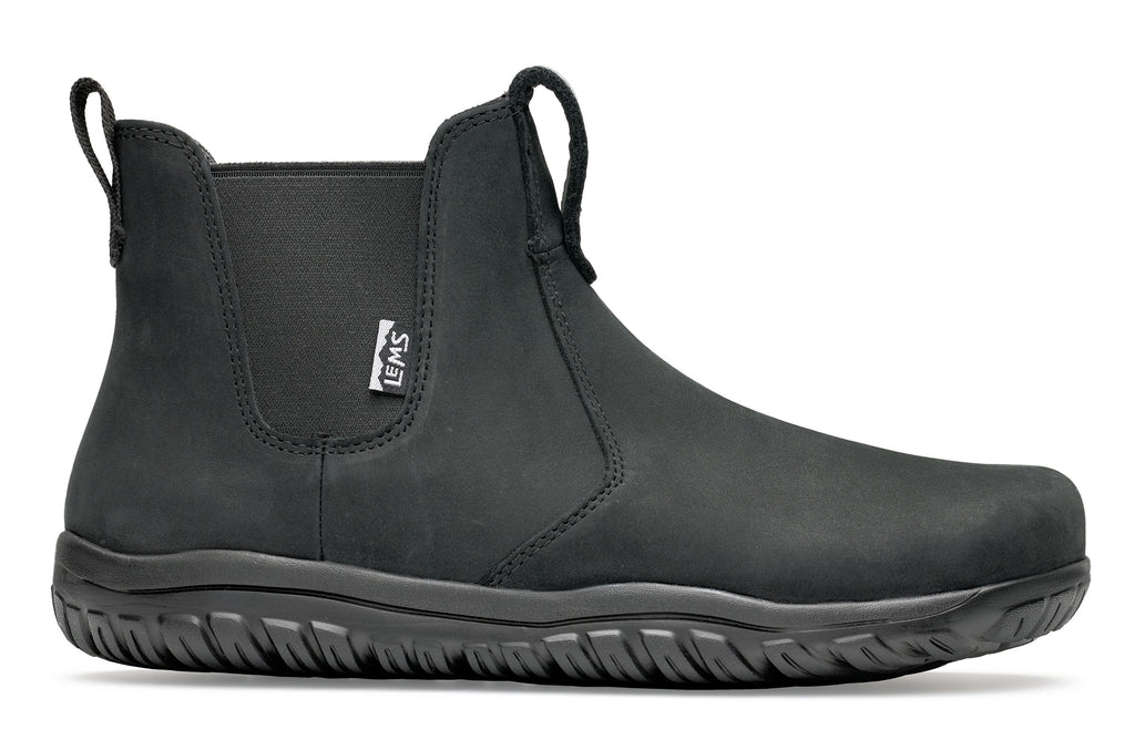 Black waterproof Chelsea boot with elastic side panels and textured rubber sole.
