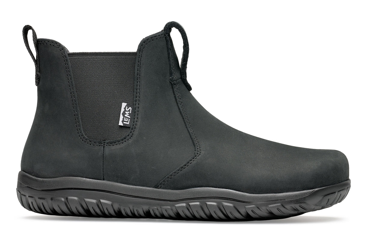 Black waterproof Chelsea boot with elastic side panels and textured rubber sole.