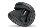 Black waterproof Chelsea boot folded to show flexibility and soft sole texture.