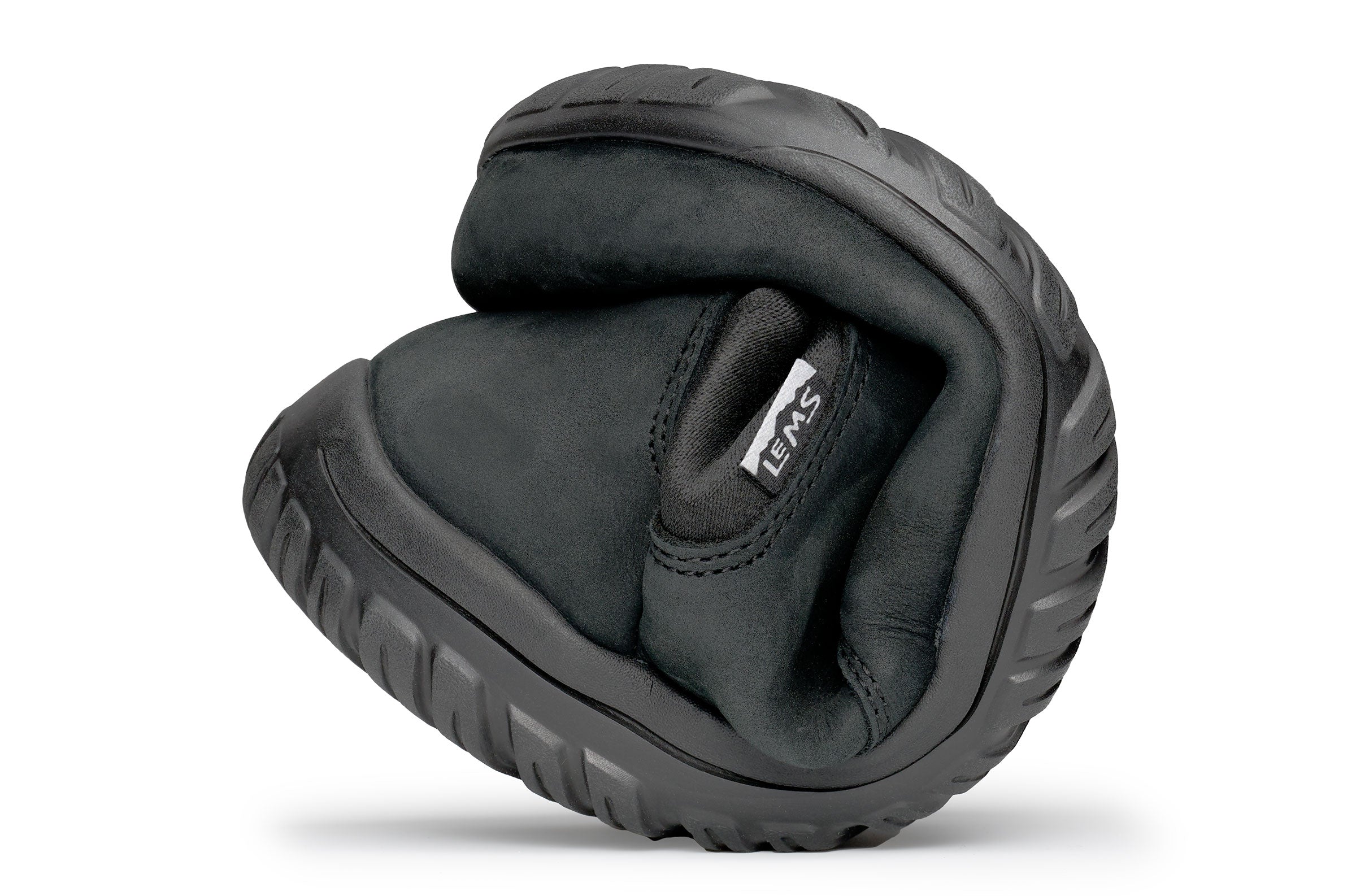 Black waterproof Chelsea boot folded to show flexibility and soft sole texture.