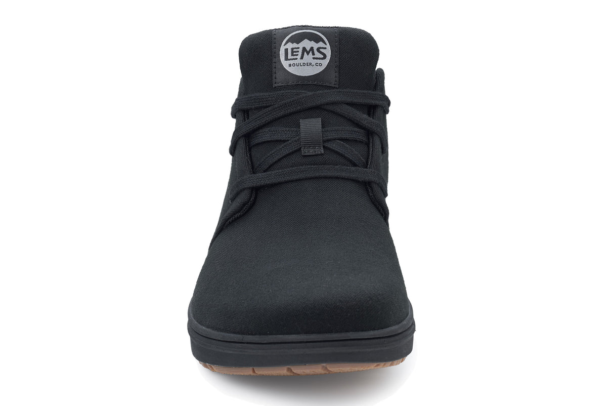 Blackout canvas Lems Chukka Grip casual shoe with black laces and gum sole, front view.
