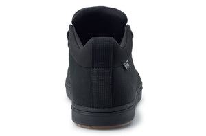 Black canvas Lems Chukka Grip shoe from rear with black rubber sole and heel tab.