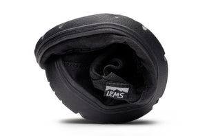 Black flexible Lems Drifter casual shoe folded to show its pliable sole and interior lining.