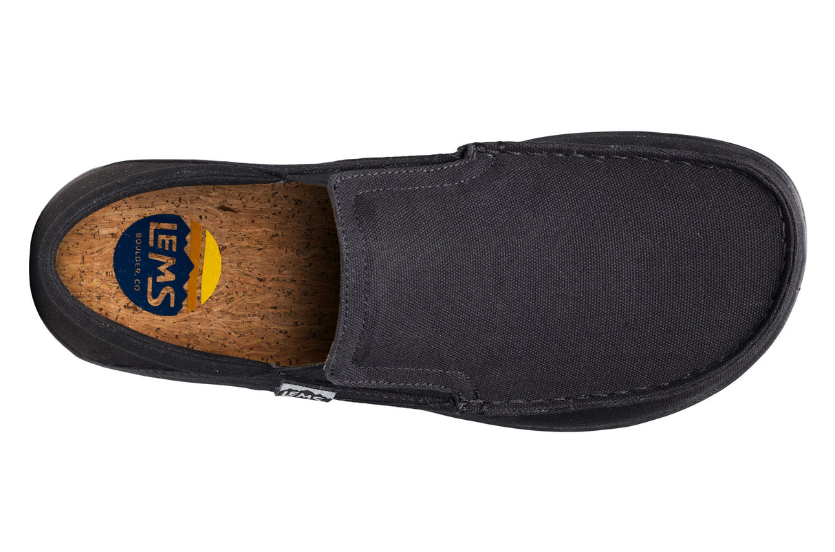 Black slip-on casual shoe with canvas upper and cork insole, branded with Lems logo.