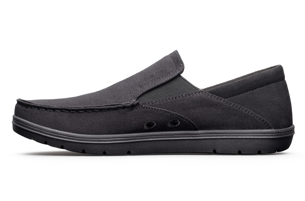Black canvas slip-on casual shoe with low profile sole and subtle stitching details.