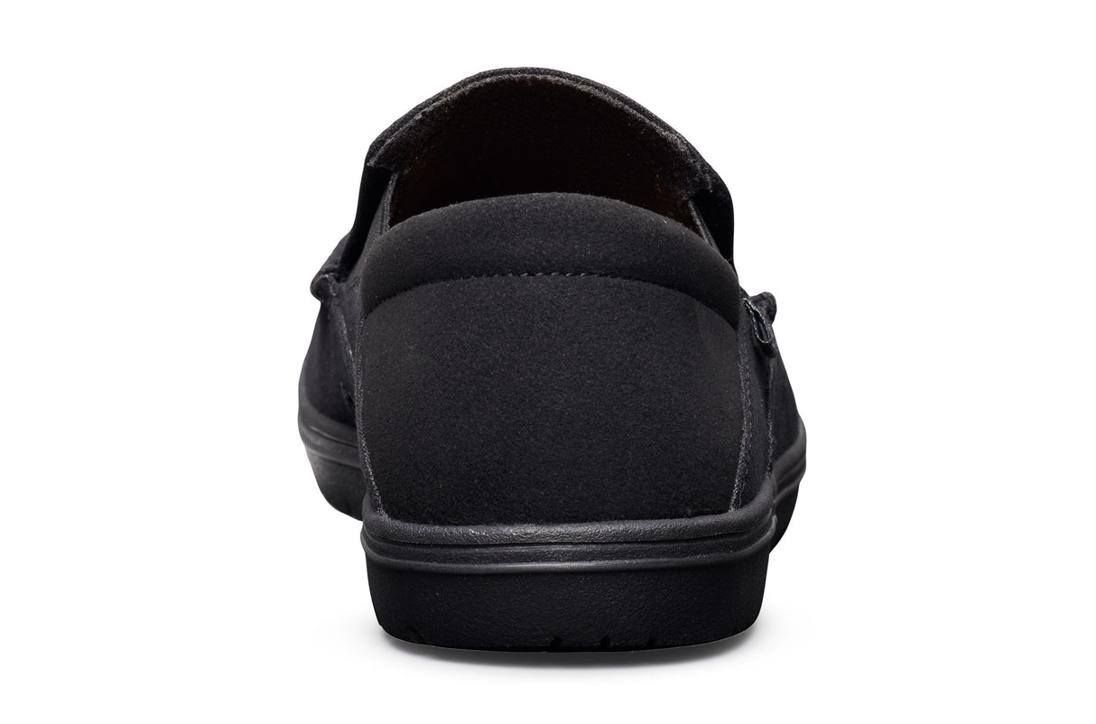 Black casual slip-on shoe with low profile sole and fabric upper, viewed from back.