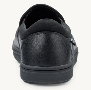 Black leather casual sneaker with padded collar and grip sole viewed from the back.