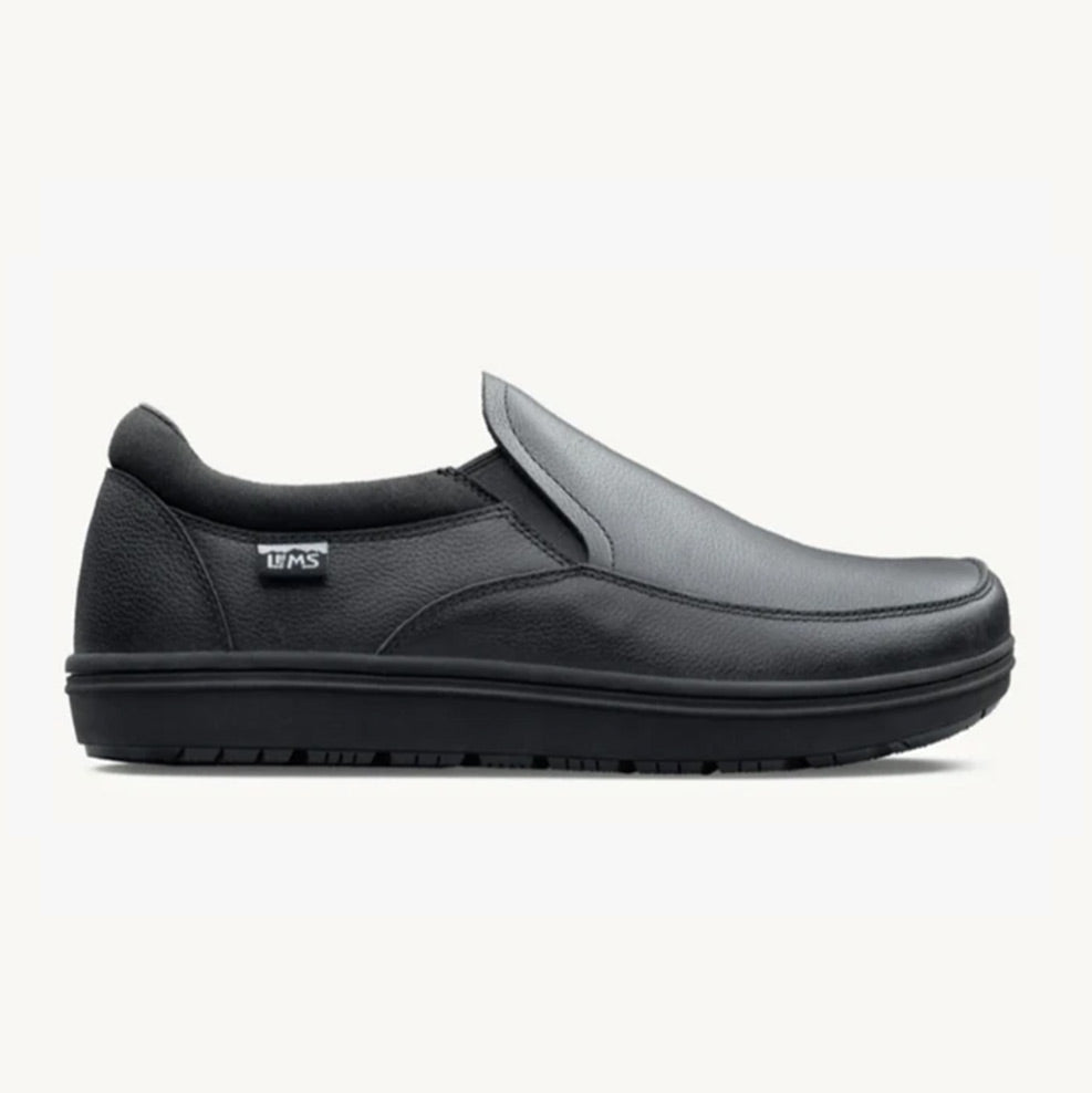 Black slip-on casual shoe with minimalist design, rounded toe, and flexible sole.