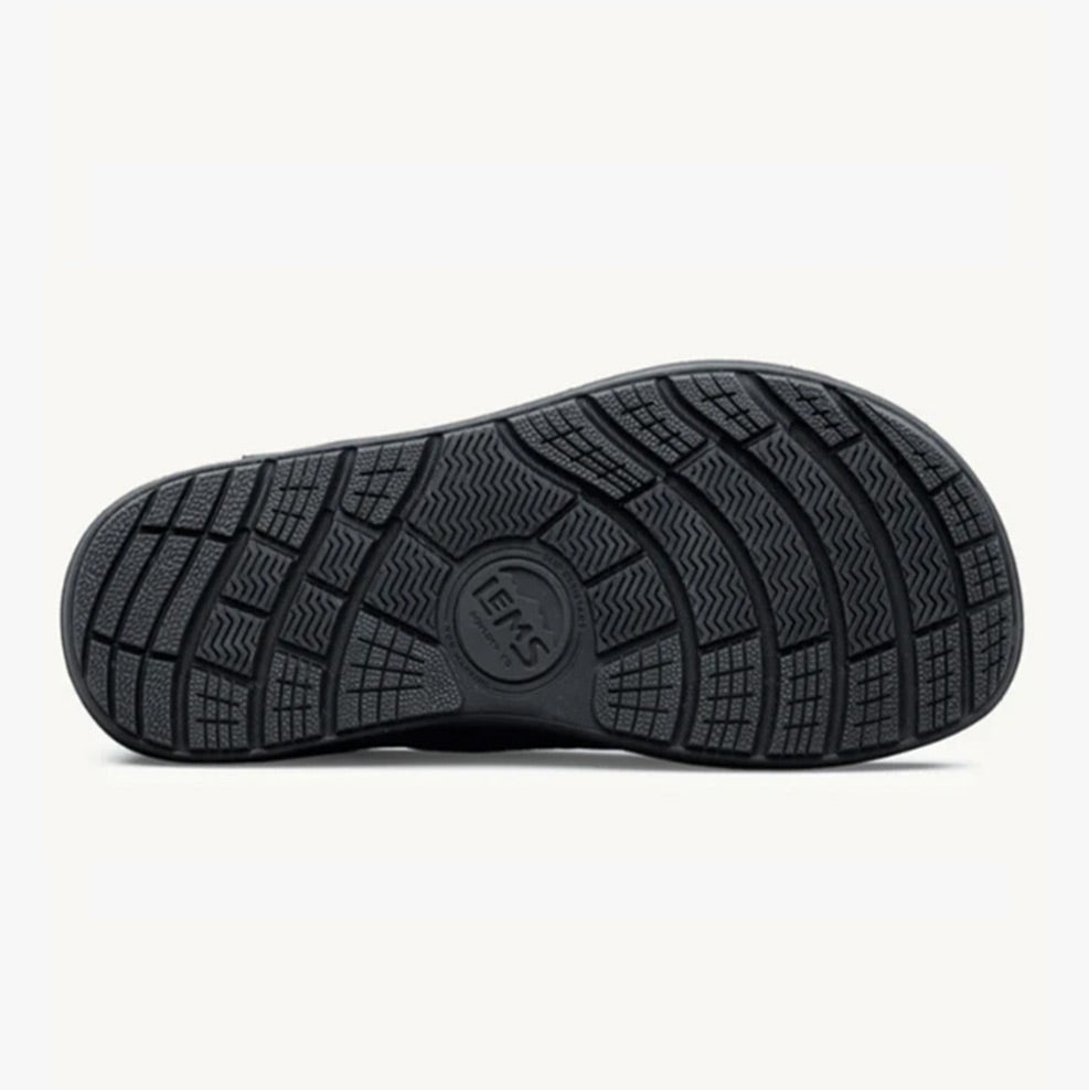 Black rubber outsole with multidirectional tread pattern and Lems logo in center.
